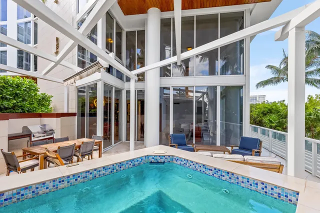 a view of a patio with couches and a fire pit