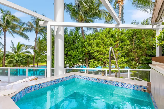 a dining room with furniture and large windows