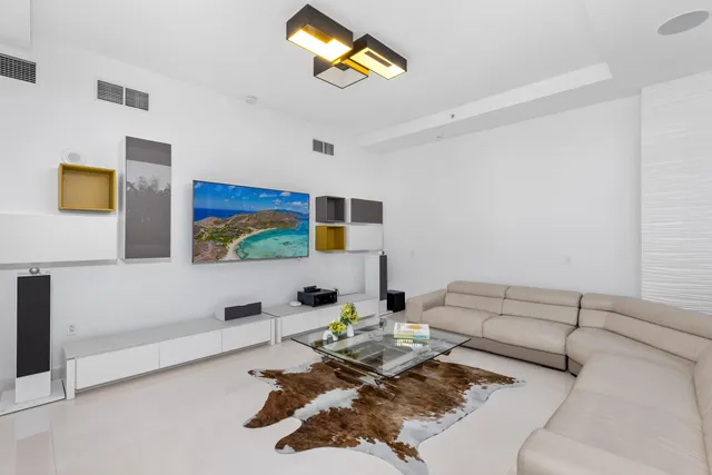 a living room with furniture and painting on the wall