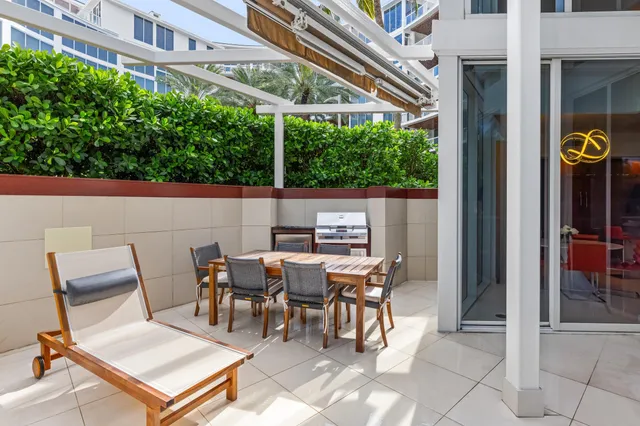 a view of a building with a backyard and sitting area