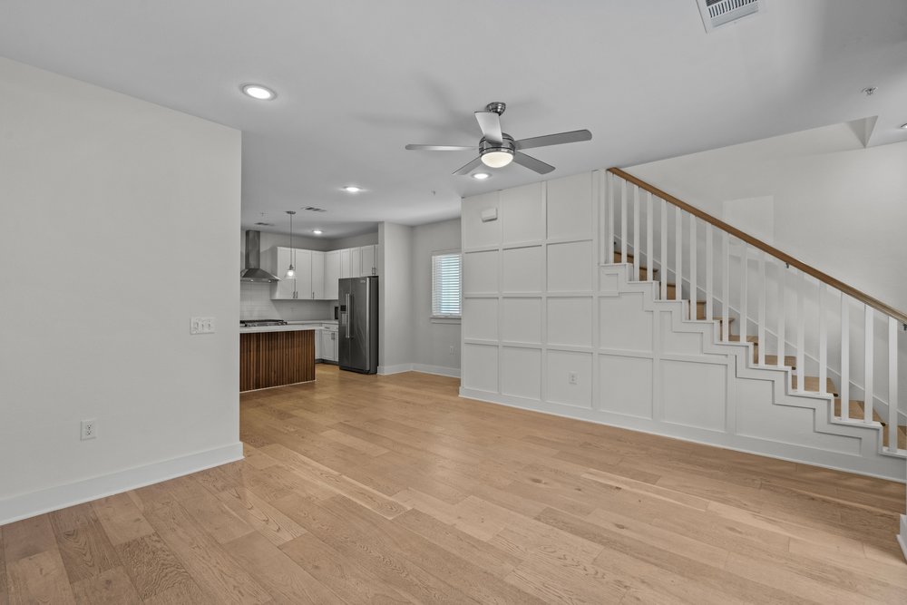 2827 Manor Road, Unit 2201 Austin, TX 78722 - Photo 6 of 40 Open-concept living area with wood-finish flooring, recessed lighting, and a modern ceiling fan