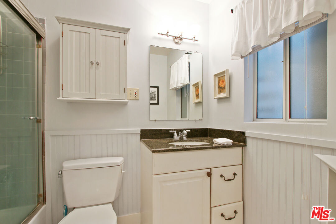 619 North Plymouth Boulevard, Unit 619 Los Angeles, CA 90004 - Photo 11 of 15 a bathroom with a sink toilet and shower