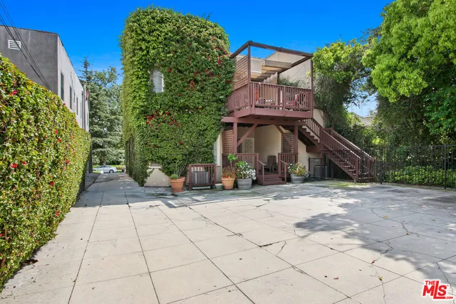 a view of a street with potted plants