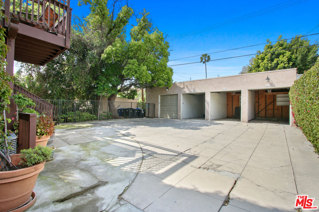 619 North Plymouth Boulevard, Unit 619 Los Angeles, CA 90004 - Photo 15 of 15 a view of a house with a yard and potted plants