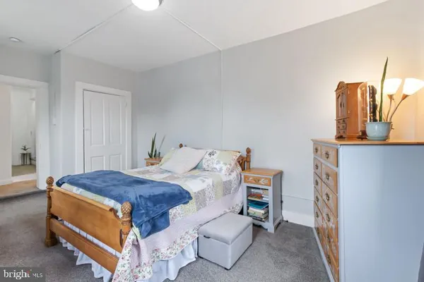 a spacious bedroom with a bed and a couch