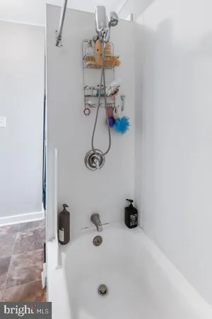 a bathroom with a granite countertop toilet a sink and a shower