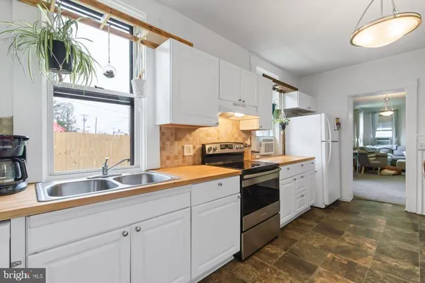 a kitchen with a sink cabinets and window