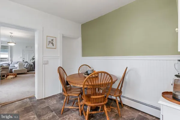 a view of a dining room with furniture and a potted plant
