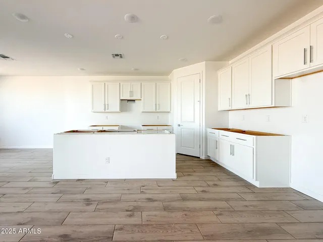 a view white cabinets with wooden floor