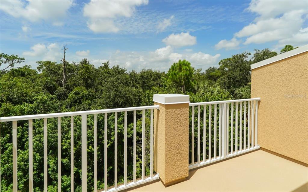 7339 Black Walnut Way Lakewood Ranch, FL 34202 - Photo 14 of 27 a balcony with trees in front of it