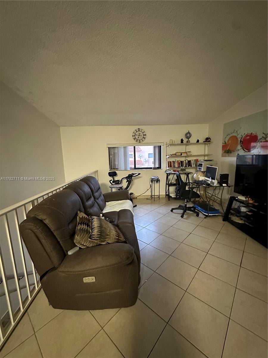 7795 West 29th Way, Unit 201 Hialeah, FL 33018 - Photo 13 of 15 a living room with furniture and a flat screen tv