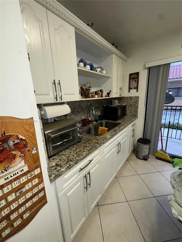 a bathroom with a toilet a sink a shower and mirror