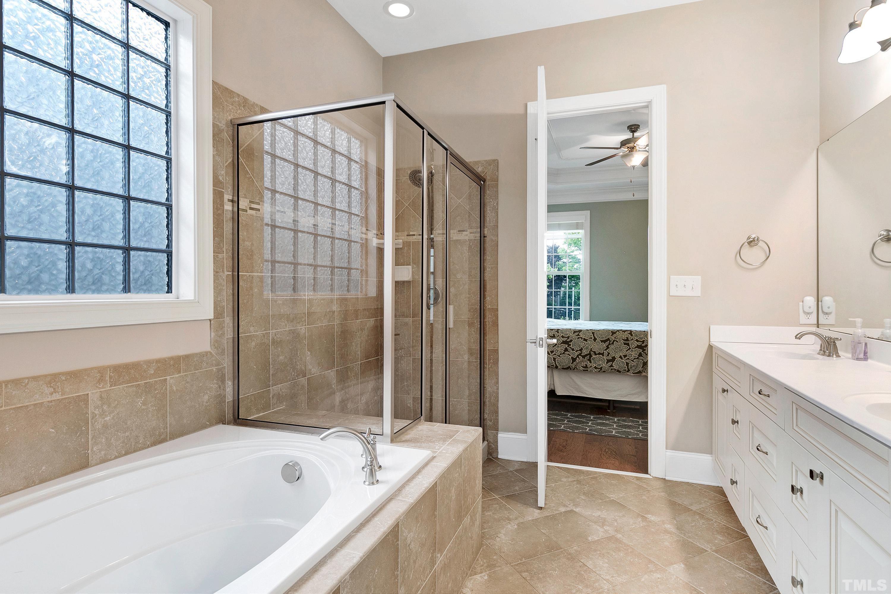 1001 Ambergate Station Apex, NC 27502 - Photo 20 of 49 a bathroom with a bathtub and a sink