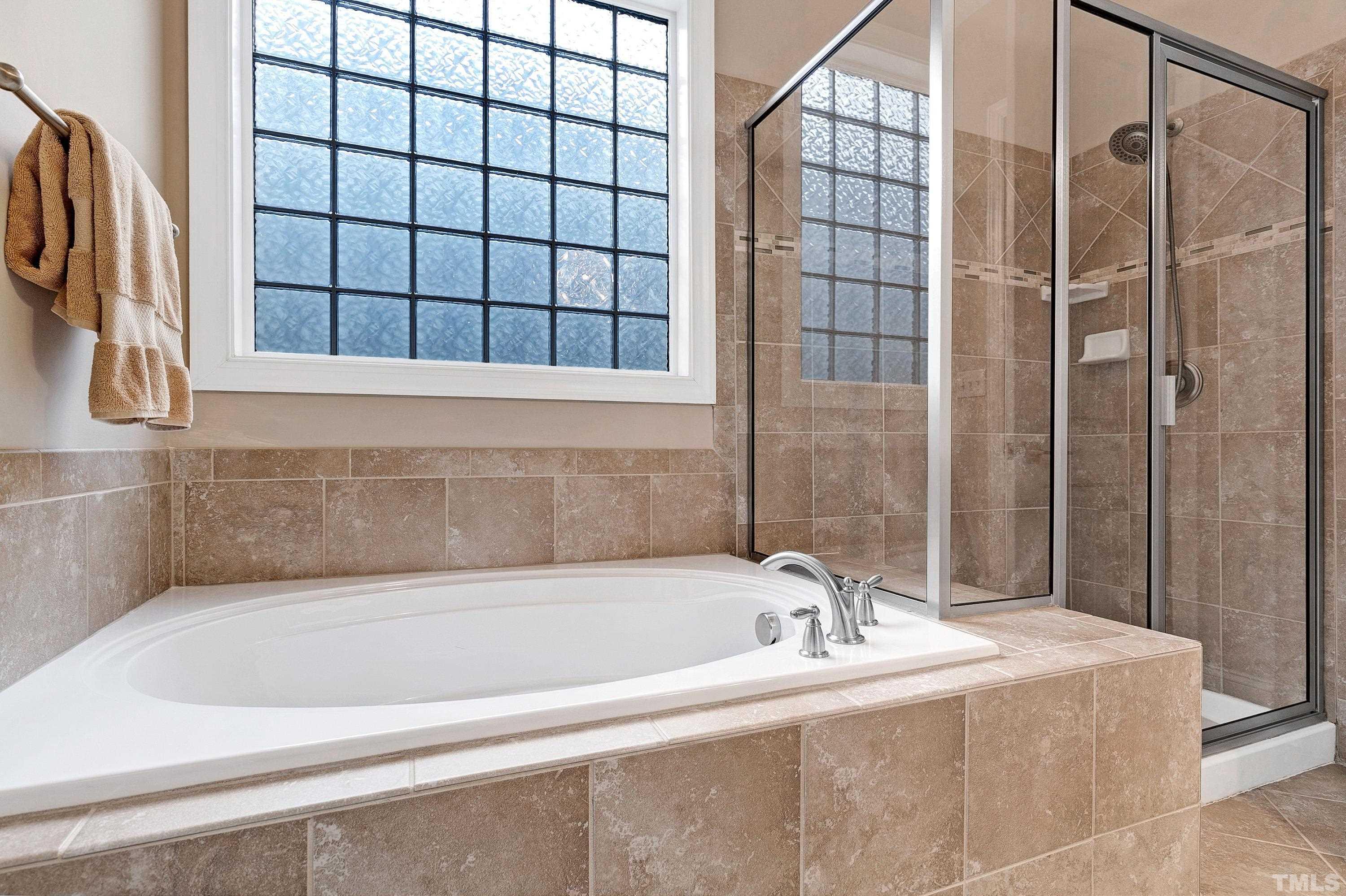 1001 Ambergate Station Apex, NC 27502 - Photo 21 of 49 a bathroom with a bathtub and shower