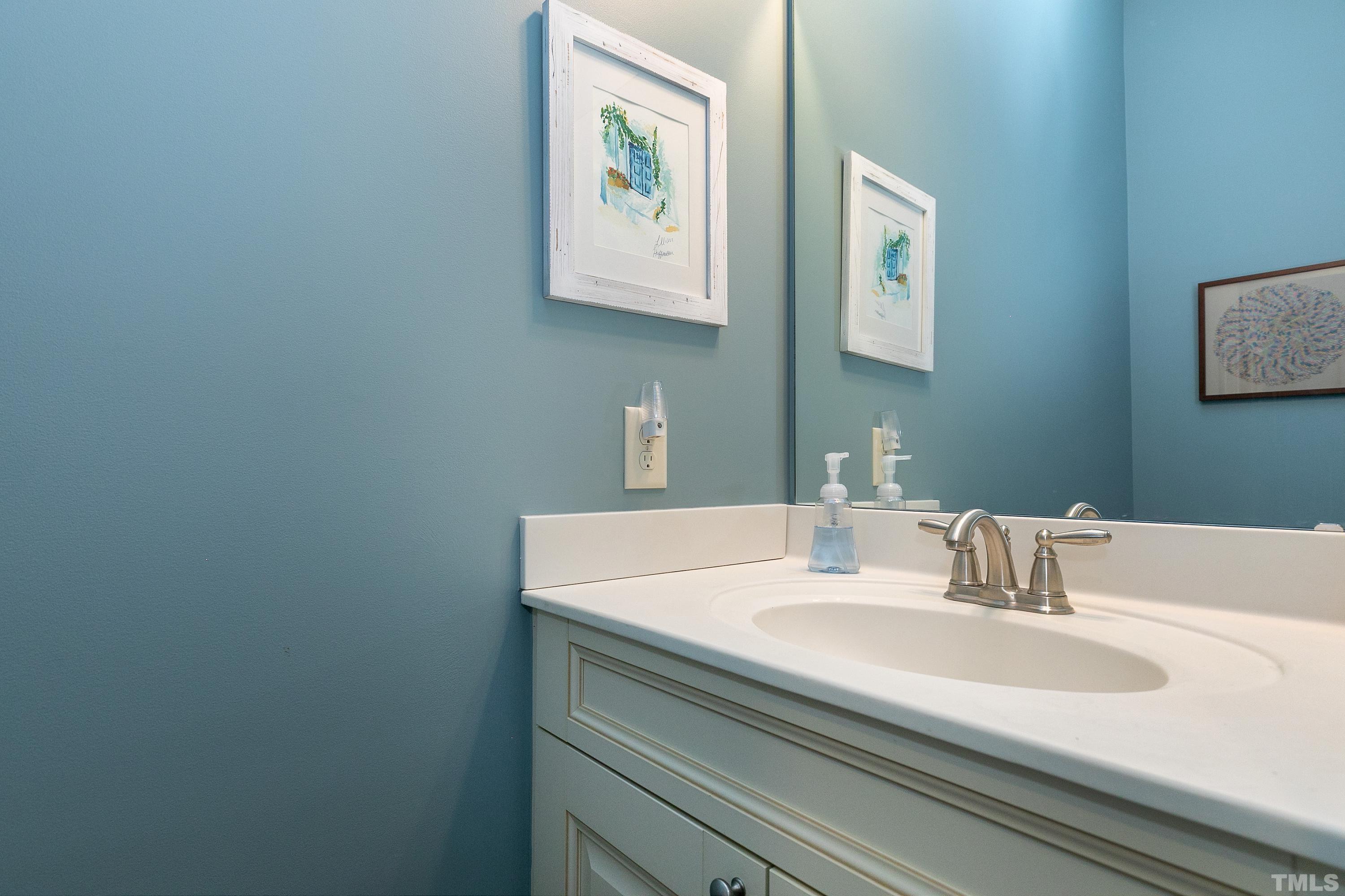 1001 Ambergate Station Apex, NC 27502 - Photo 22 of 49 a bathroom with a sink and a mirror