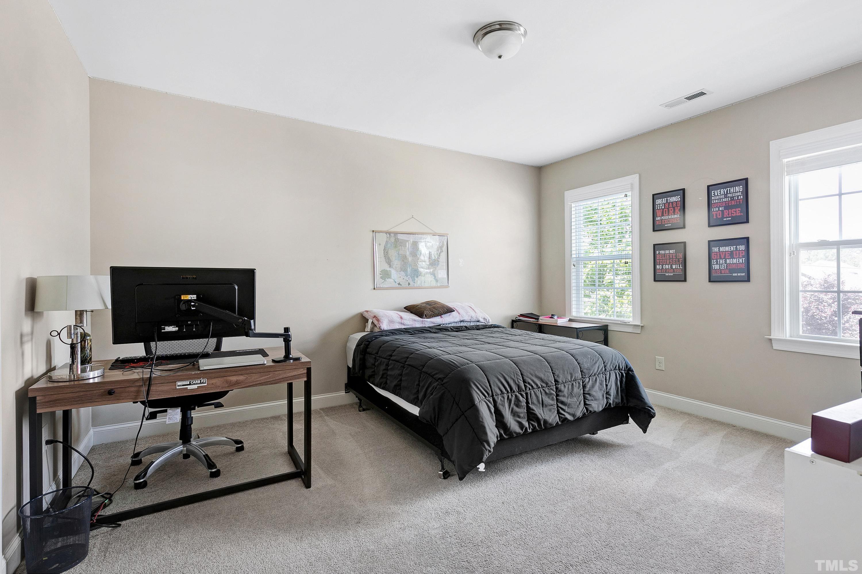 1001 Ambergate Station Apex, NC 27502 - Photo 27 of 49 a bedroom with a bed and a window