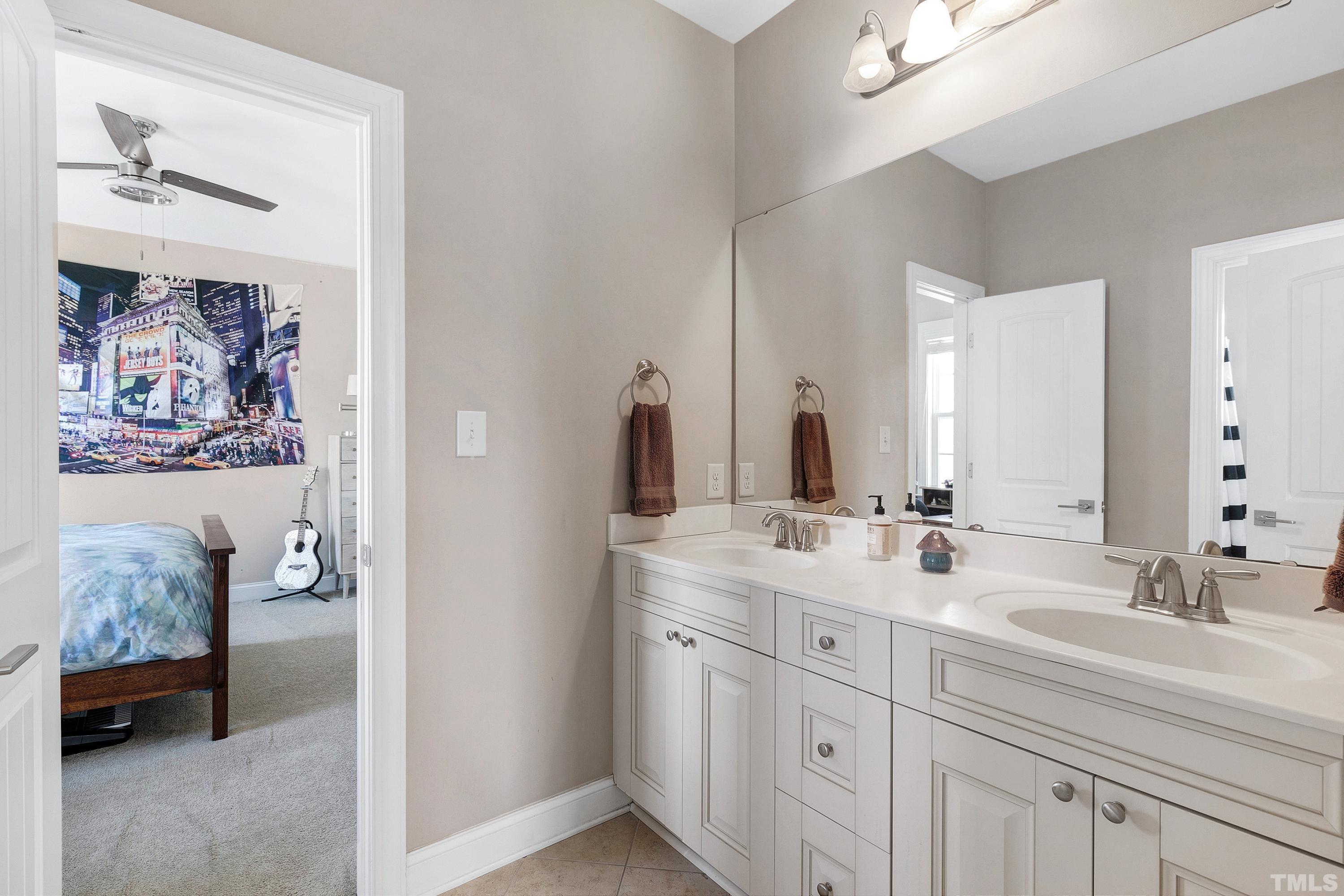 1001 Ambergate Station Apex, NC 27502 - Photo 29 of 49 a bathroom with a double vanity sink and a mirror