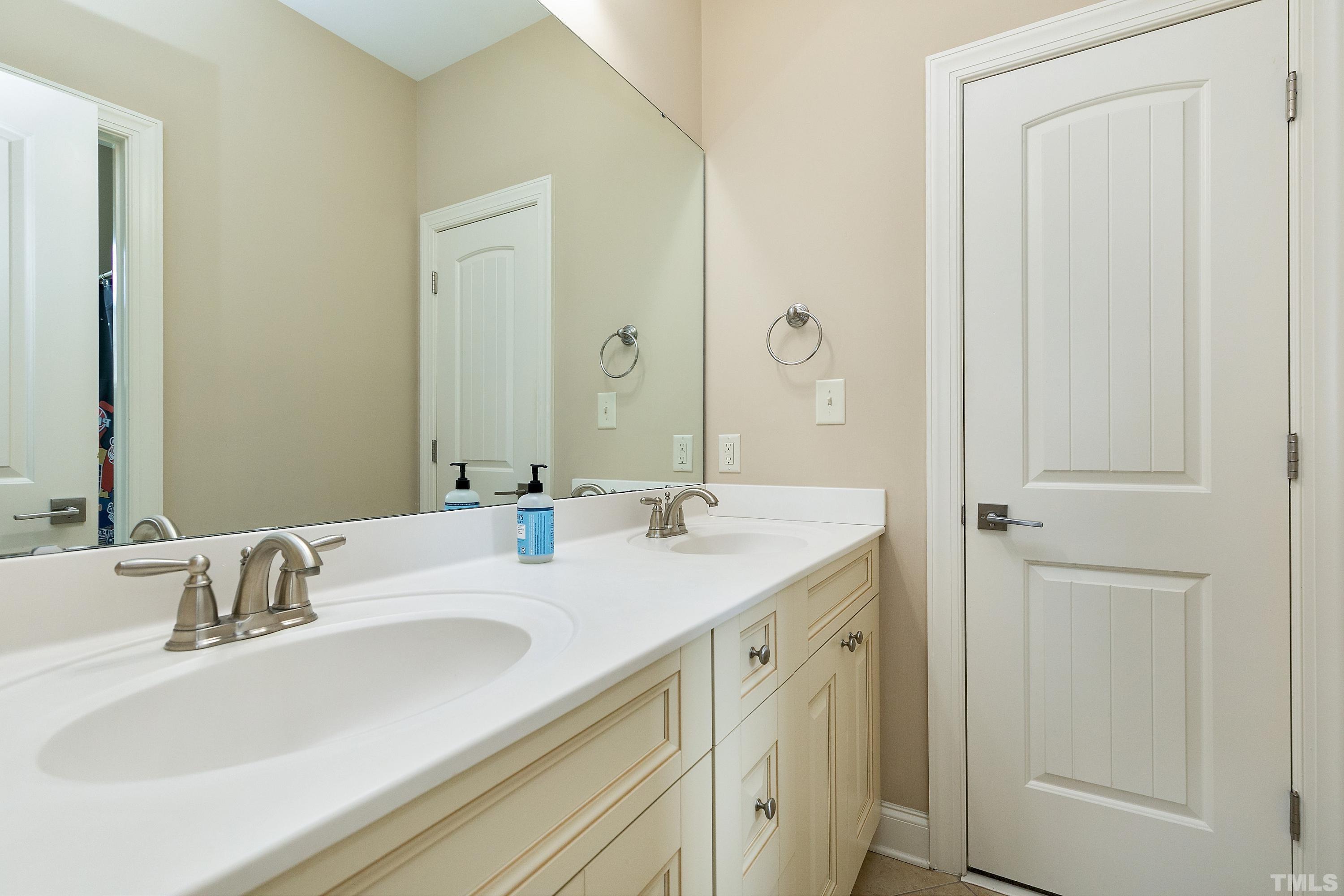 1001 Ambergate Station Apex, NC 27502 - Photo 31 of 49 a bathroom with a double vanity sink and a mirror