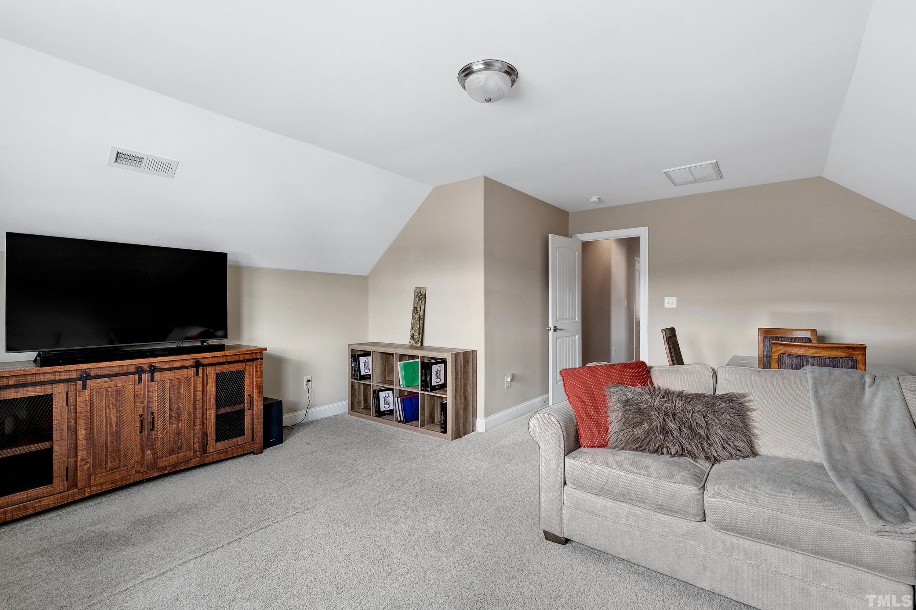1001 Ambergate Station Apex, NC 27502 - Photo 33 of 49 a living room with furniture and a flat screen tv
