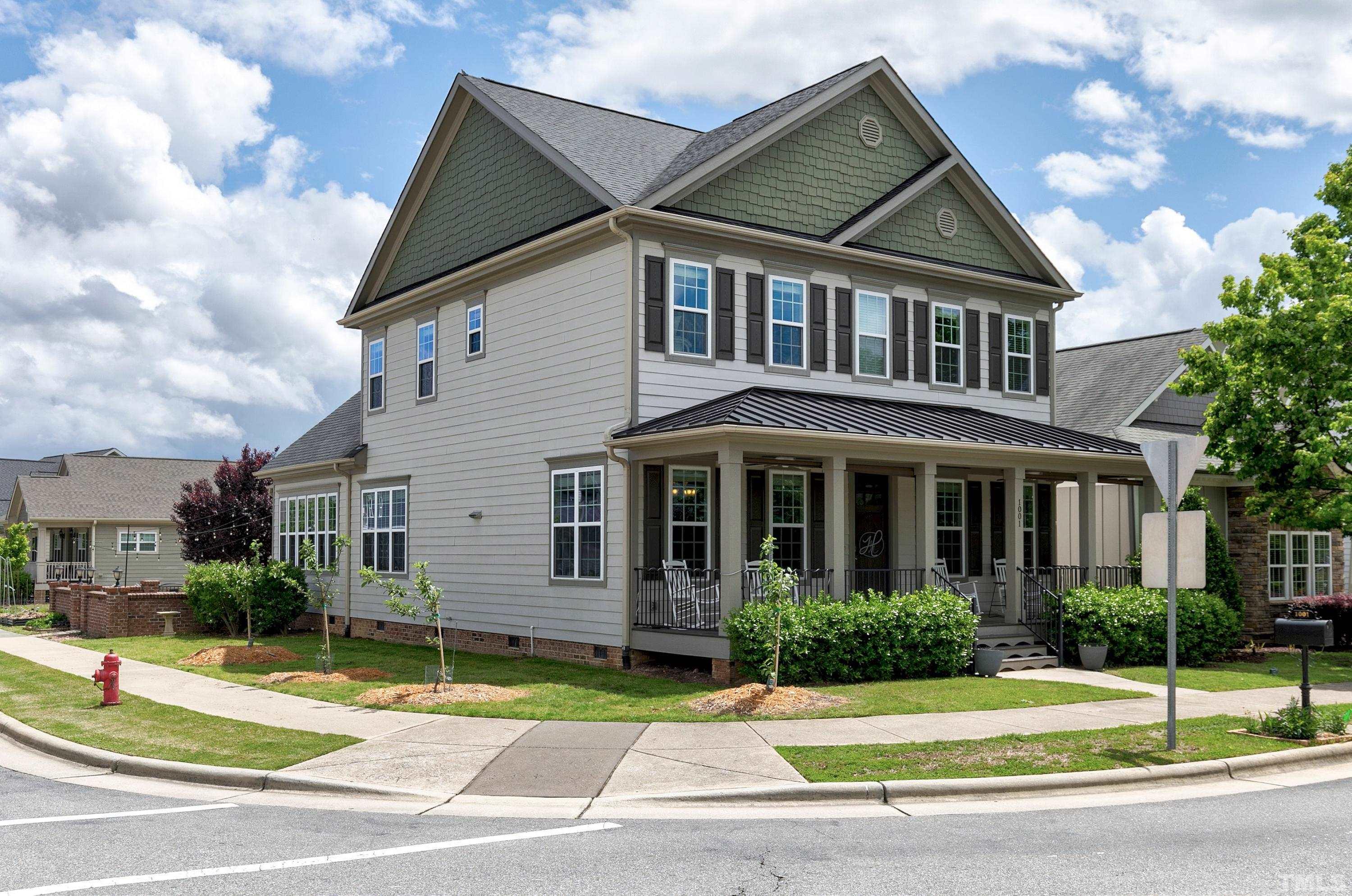 1001 Ambergate Station Apex, NC 27502 - Photo 35 of 49 a view of a white house with a yard and plants