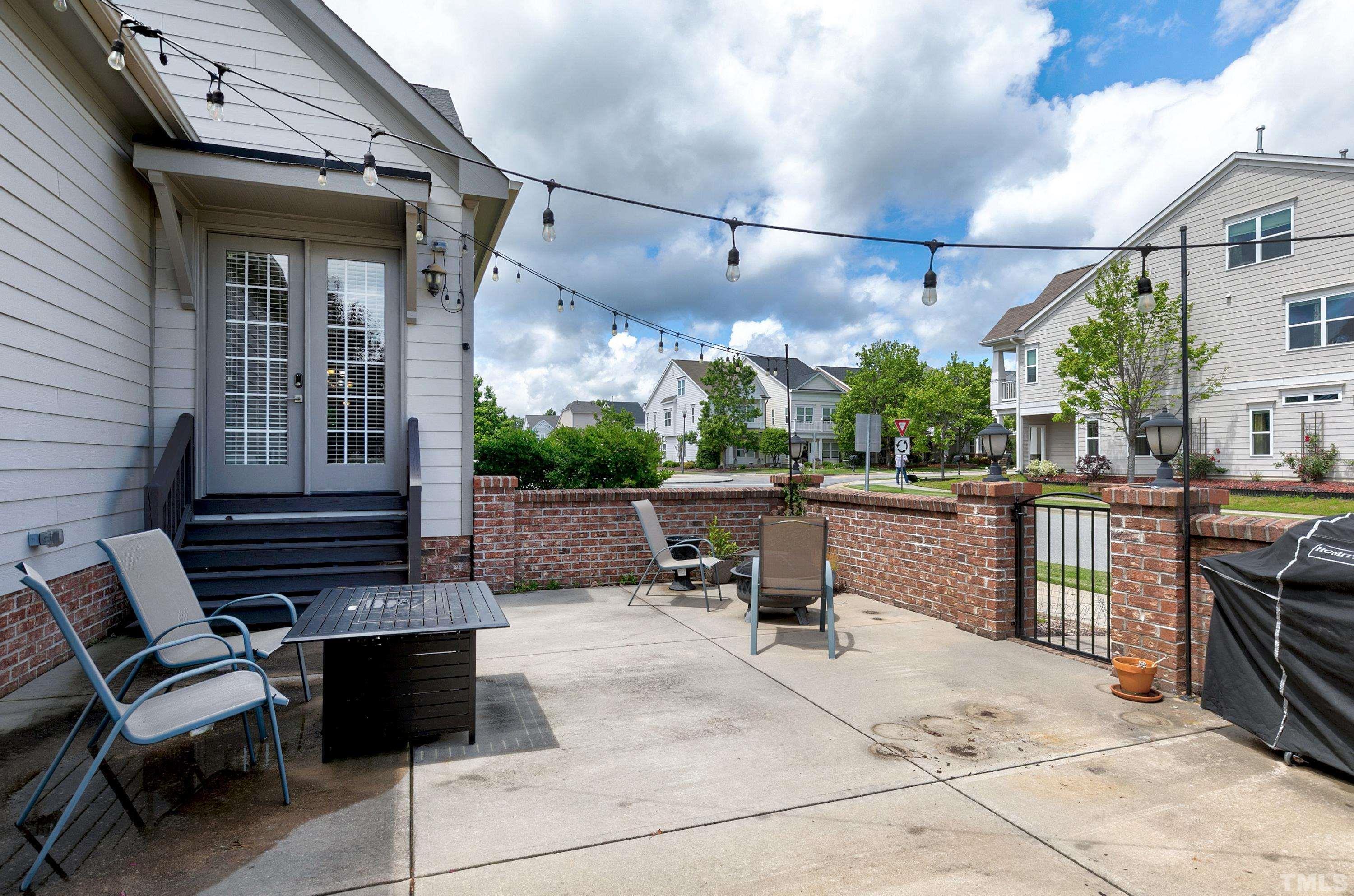 1001 Ambergate Station Apex, NC 27502 - Photo 40 of 49 a view of a patio with dining table and chairs with wooden fence