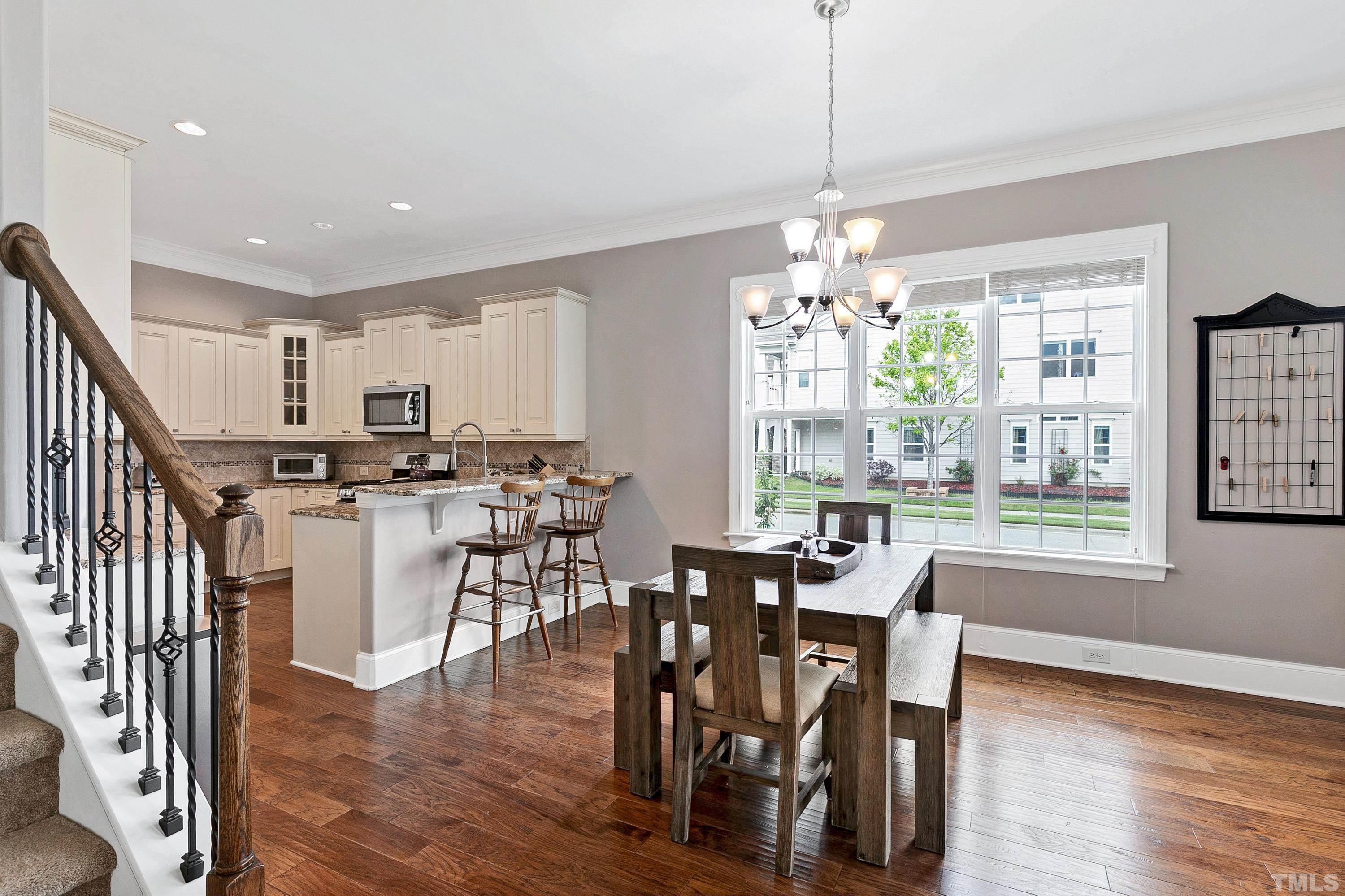 1001 Ambergate Station Apex, NC 27502 - Photo 6 of 49 a view of a dining room with furniture window and wooden floor