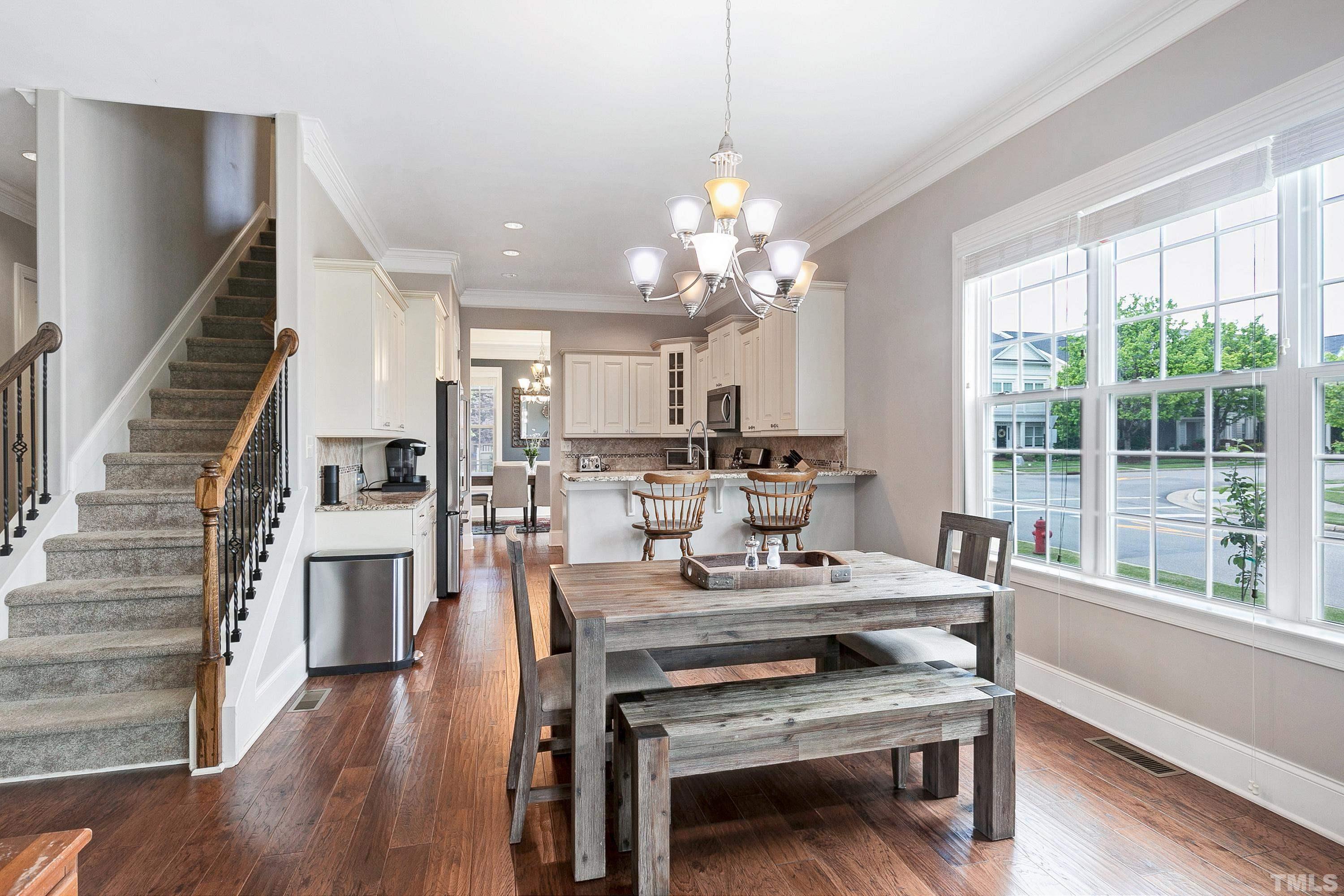 1001 Ambergate Station Apex, NC 27502 - Photo 7 of 49 a view of a dining room with furniture window and wooden floor