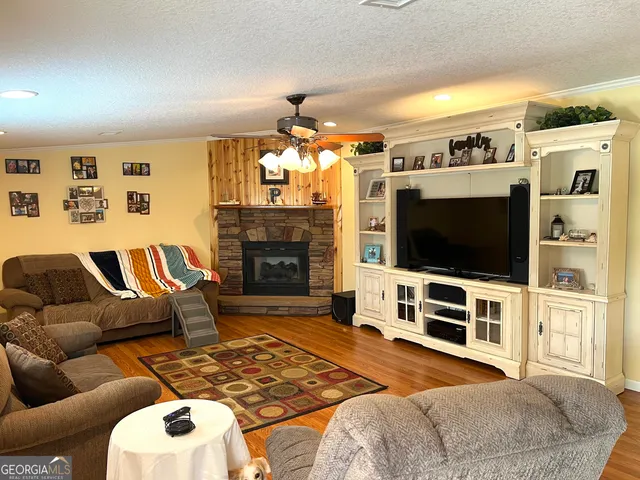 a bedroom with furniture and a flat screen tv