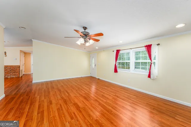 wooden floor in an empty room with a window