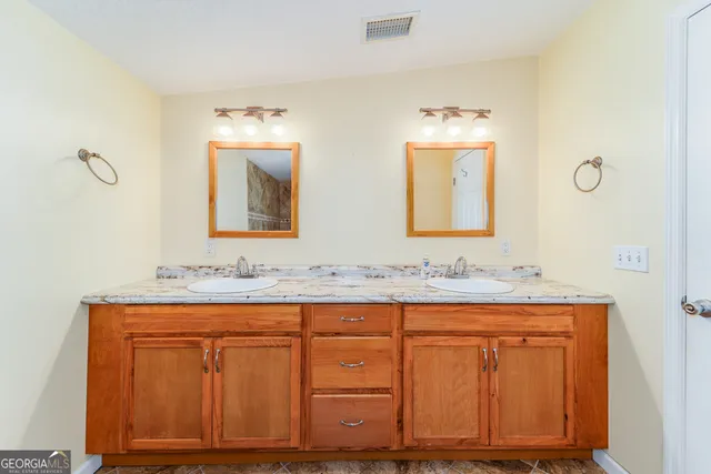 a bathroom with 2 sink and a mirror