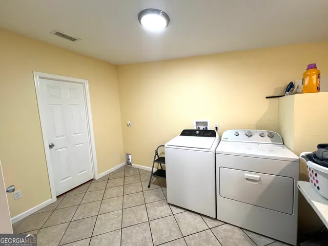 a utility room with dryer and washer