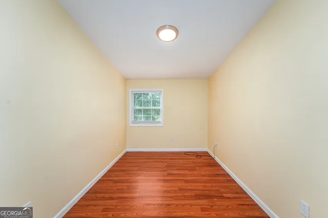a view of a room with wooden floor and window