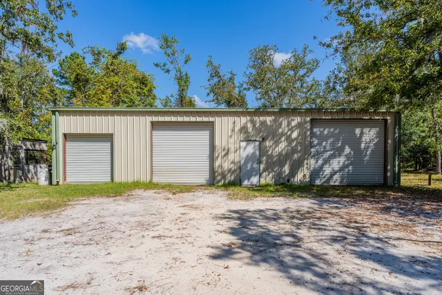 a view of a house with a yard covered in snow