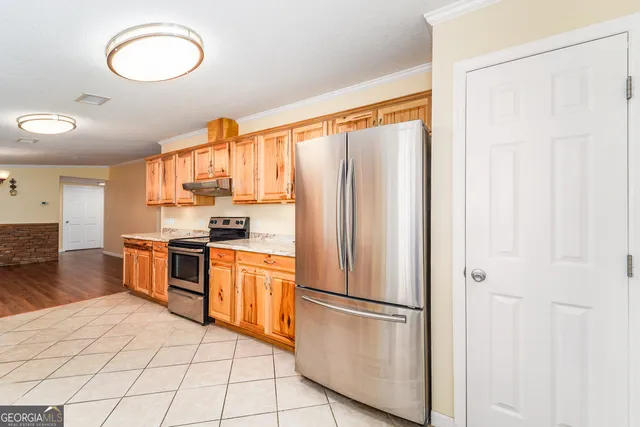 a kitchen with stainless steel appliances a refrigerator sink and cabinets