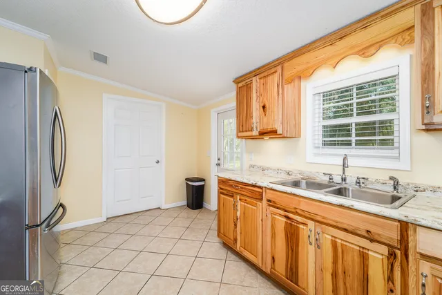 a kitchen with stainless steel appliances granite countertop a sink and a refrigerator