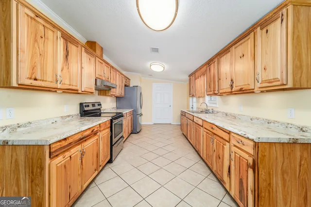 a kitchen with stainless steel appliances granite countertop a sink and cabinets