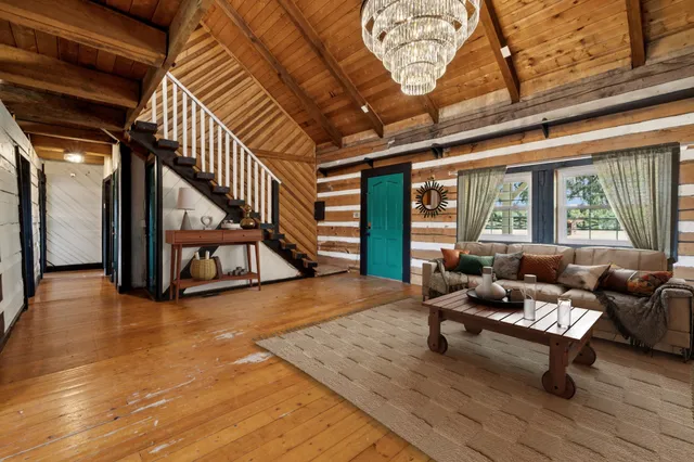 a view of empty room with wooden floor and fireplace