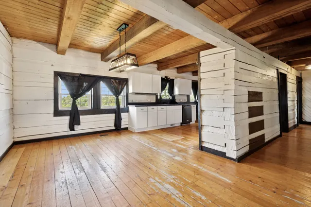 a bathroom with a granite countertop sink and a large mirror