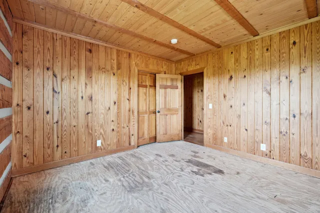 a view of a hallway with wooden shelves