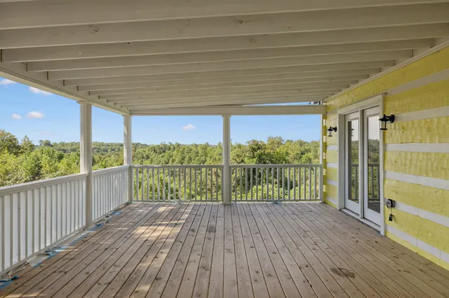 a view of a balcony with wooden floor