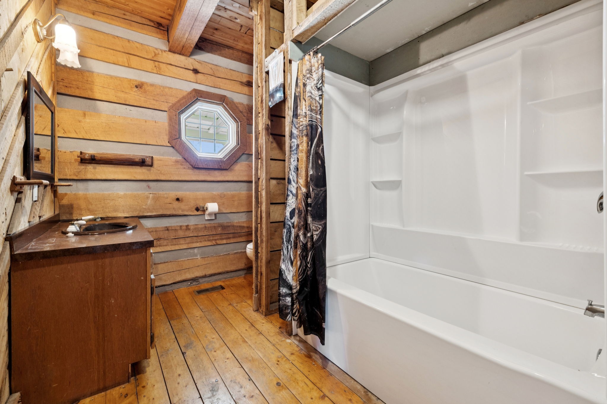 294 Ed Harris Road Ashland City, TN 37015 - Photo 52 of 65 a bathroom with a bathtub and a shower