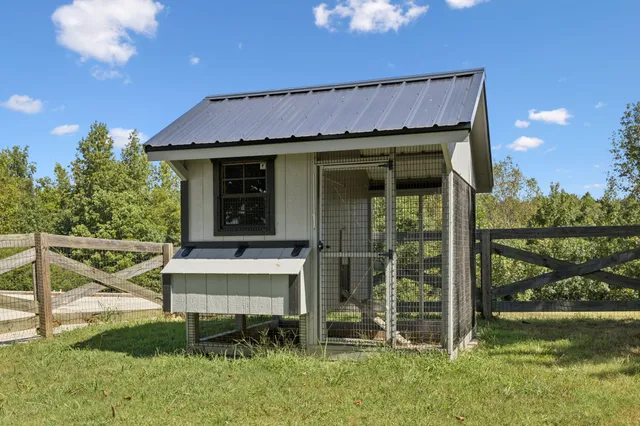 a view of a chair and table in backyard of the house