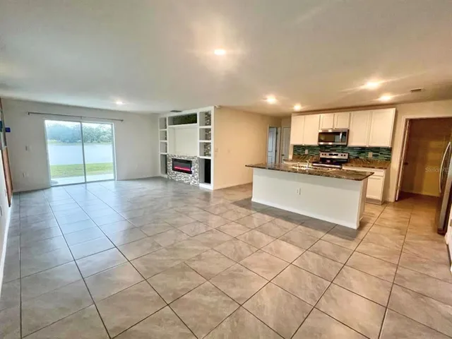 a kitchen with stainless steel appliances a stove a sink a microwave and a refrigerator