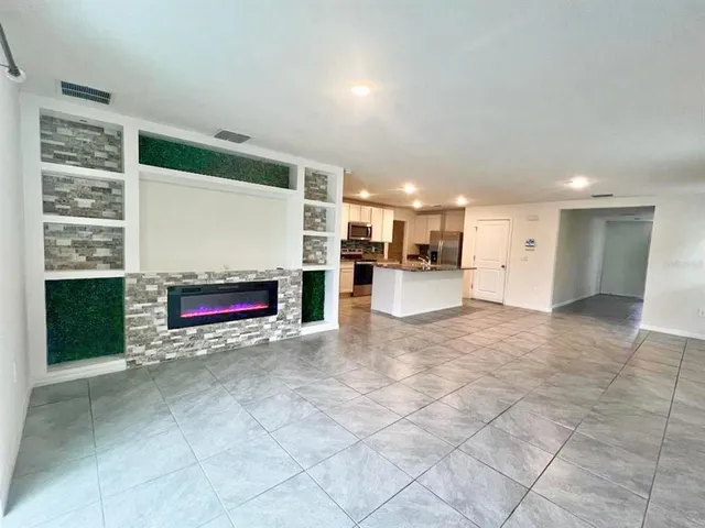a view of an empty room with a fireplace