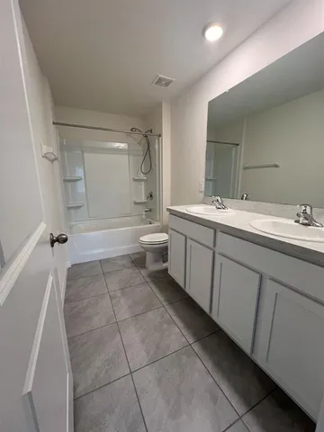 a bathroom with a sink a toilet and a bathtub