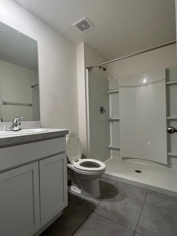 2824 Rock Sound Street Bradenton, FL 34208 - Photo 25 of 28 a bathroom with a shower sink vanity and toilet