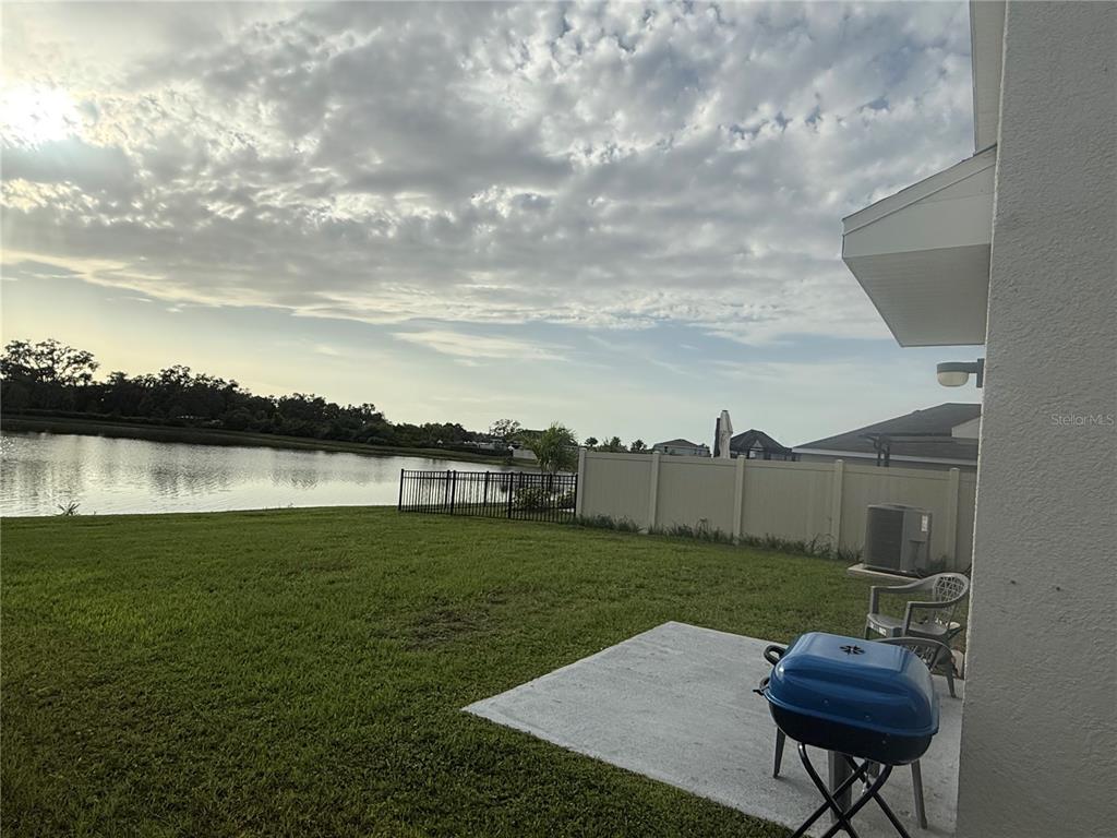 2824 Rock Sound Street Bradenton, FL 34208 - Photo 8 of 28 a view of a backyard with plants and lake