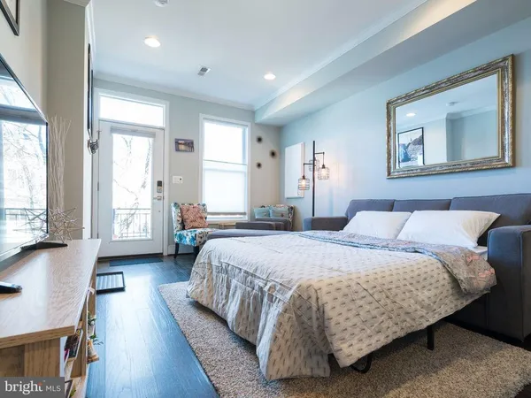 a bedroom with a bed and glass windows