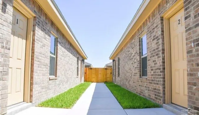 a view of a brick building next to a yard