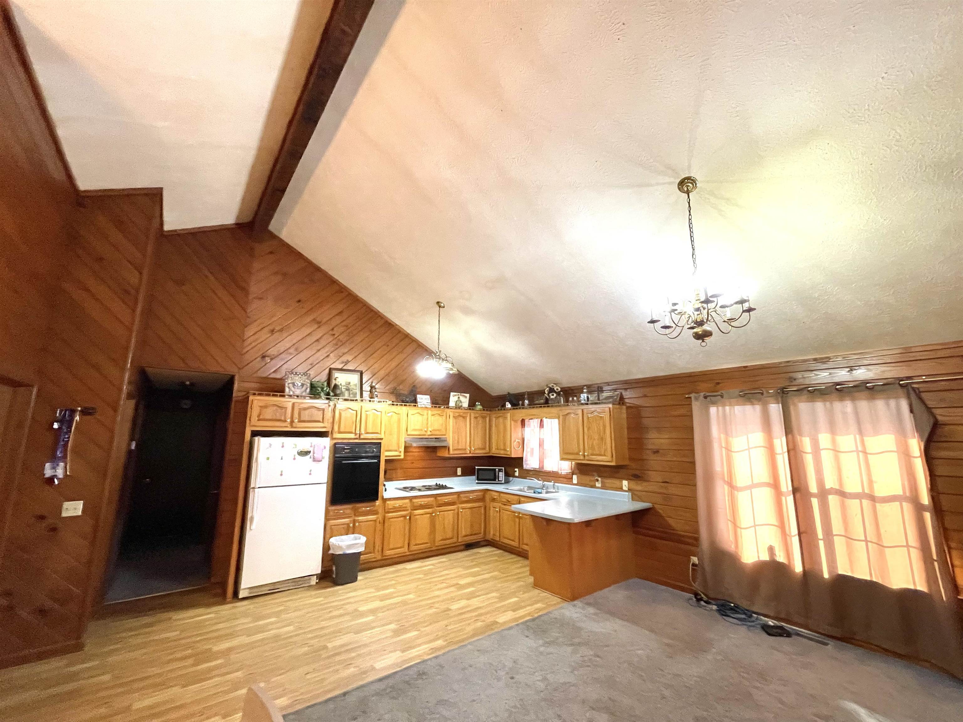 1110 Small Road Morris Chapel, TN 38361 - Photo 5 of 25 a living room with couches and kitchen view with wooden floor